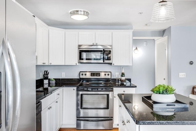 606 W Falmouth Hwy Unit 7, Falmouth, MA 02540 - kitchen featuring dark stone counters, appliances with stainless steel finishes, pendant lighting, and white cabinetry