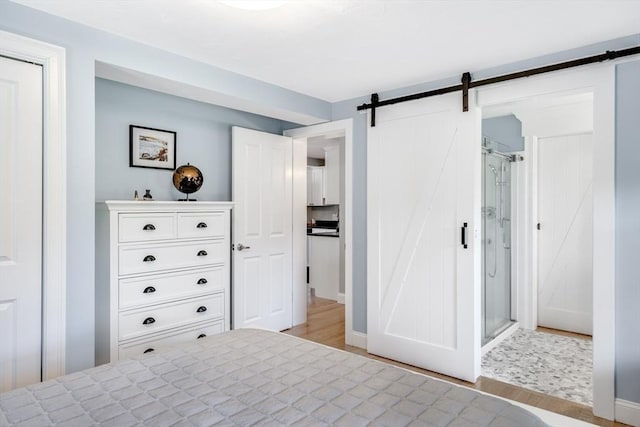 606 W Falmouth Hwy Unit 7, Falmouth, MA 02540 - bedroom with a barn door and light wood finished floors