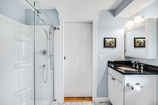 606 W Falmouth Hwy Unit 7, Falmouth, MA 02540 - bathroom featuring wood finished floors, vanity, and a stall shower