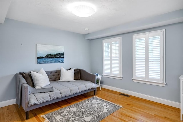 606 W Falmouth Hwy Unit 7, Falmouth, MA 02540 - living room with baseboards, light wood-style flooring, and visible vents