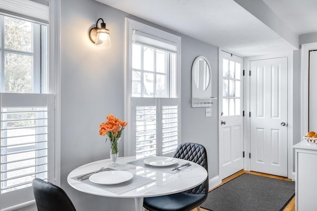 606 W Falmouth Hwy Unit 7, Falmouth, MA 02540 - dining area featuring baseboards, wood finished floors, and a wealth of natural light
