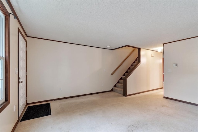 24 Mountainshire Dr Unit 24, Worcester, MA 01606 - basement featuring stairs, a textured ceiling, carpet floors, crown molding, and baseboards