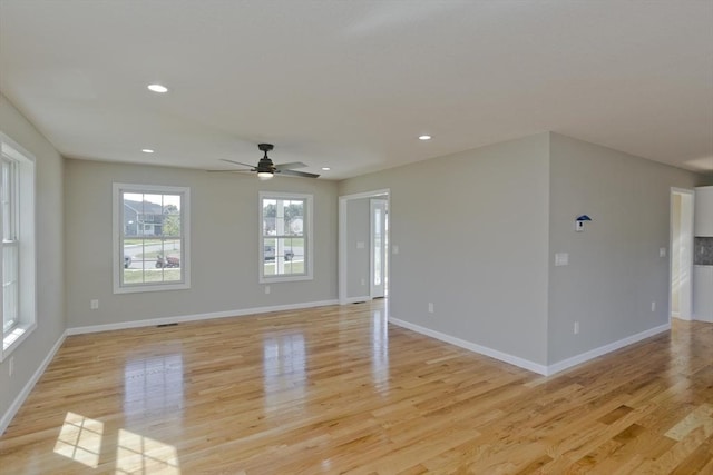 spare room with recessed lighting, ceiling fan, baseboards, and light wood-type flooring
