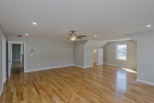 interior space featuring recessed lighting, light wood-style flooring, ceiling fan, and baseboards