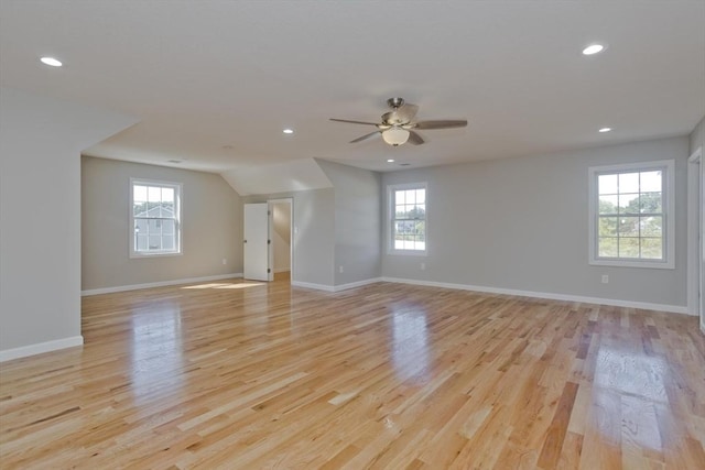 interior space featuring baseboards, light wood finished floors, ceiling fan, and a wealth of natural light