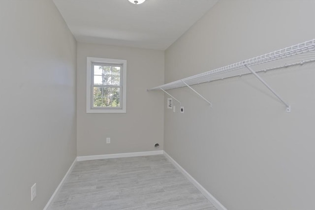 washroom featuring baseboards, hookup for an electric dryer, laundry area, and hookup for a washing machine