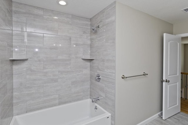 bathroom with  shower combination, visible vents, and baseboards