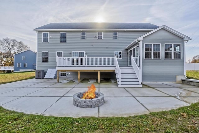 back of house with a deck, a patio area, stairway, central air condition unit, and an outdoor fire pit