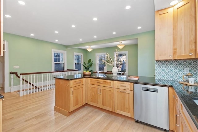 kitchen featuring decorative backsplash, stainless steel dishwasher, light wood-style floors, light brown cabinets, and a peninsula