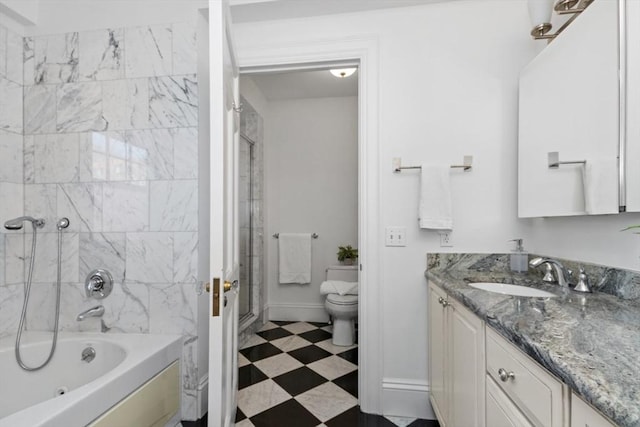 full bathroom featuring toilet, bathing tub / shower combination, baseboards, vanity, and tile patterned floors