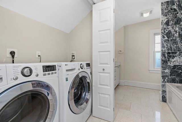 laundry room featuring laundry area, baseboards, and washer and clothes dryer