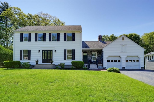 13 Woodland Dr, Hudson, MA 01749 - colonial inspired home featuring driveway, a front lawn, a chimney, french doors, and an attached garage