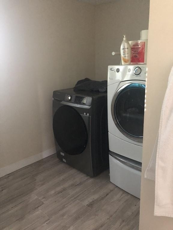 31 Benham St, Orange, MA 01364 - laundry room featuring washer and clothes dryer and wood finished floors