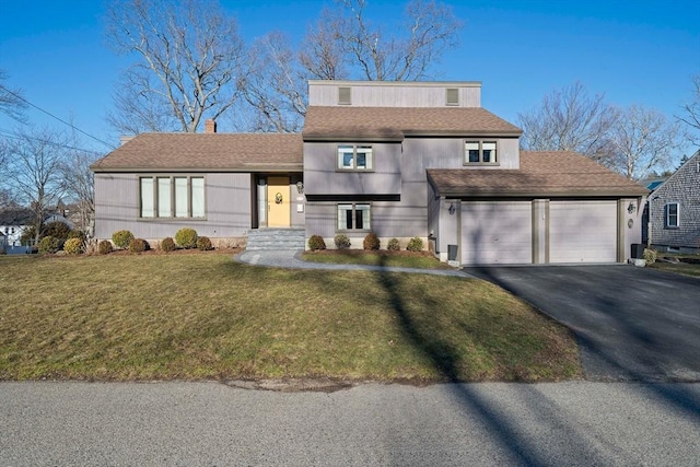 view of front facade featuring aphalt driveway, a garage, a shingled roof, and a front lawn