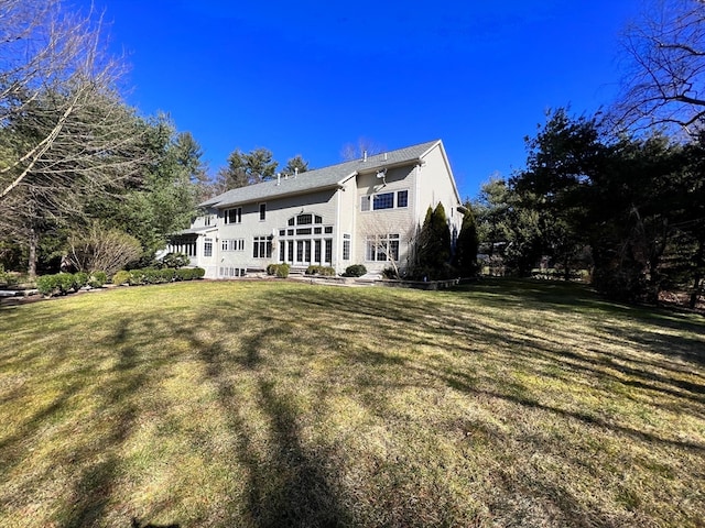 rear view of property with a yard