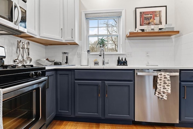 kitchen featuring white cabinetry, sink, tasteful backsplash, and stainless steel appliances