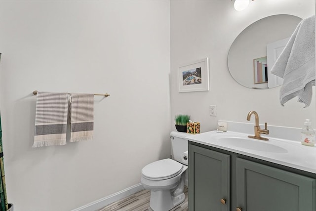 bathroom featuring vanity, hardwood / wood-style floors, and toilet