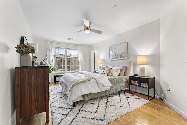 bedroom with ceiling fan and light wood-type flooring