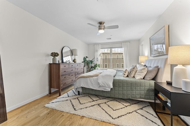 bedroom with ceiling fan and light hardwood / wood-style flooring