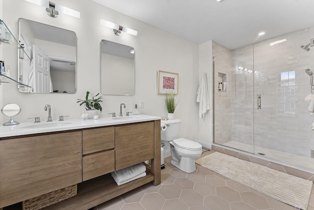 bathroom with tile patterned flooring, vanity, toilet, and a shower with shower door