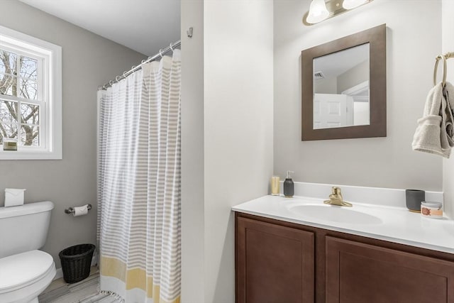 bathroom featuring vanity and toilet