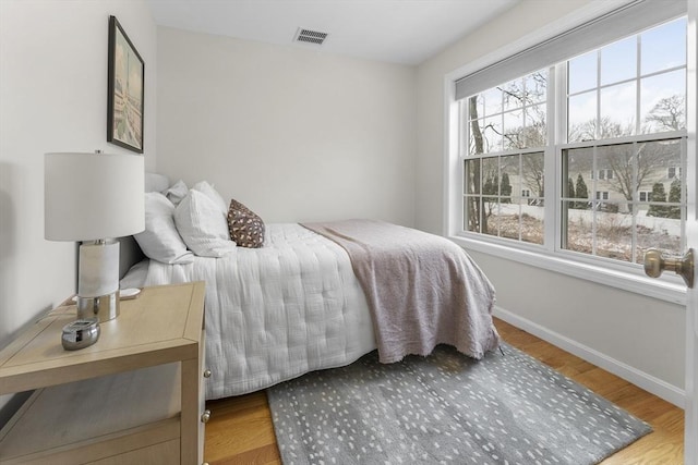 bedroom with hardwood / wood-style flooring