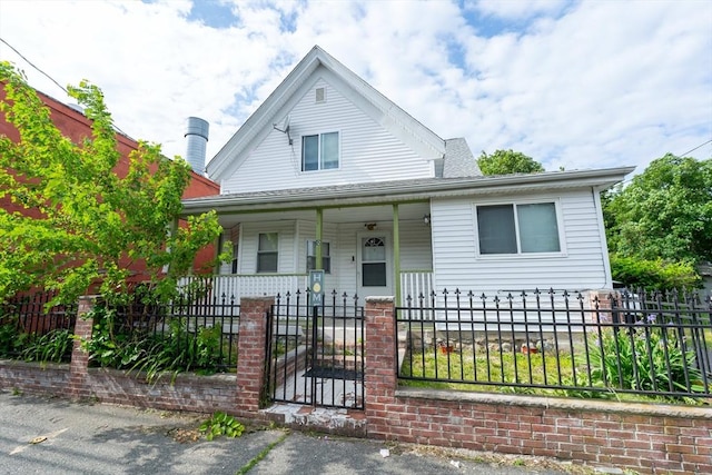 12 Charles St, Brockton, MA 02301 - view of front of home featuring covered porch, a fenced front yard, and a gate