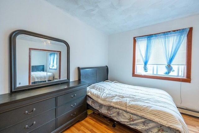 12 Charles St, Brockton, MA 02301 - bedroom featuring light wood finished floors, multiple windows, and a baseboard radiator