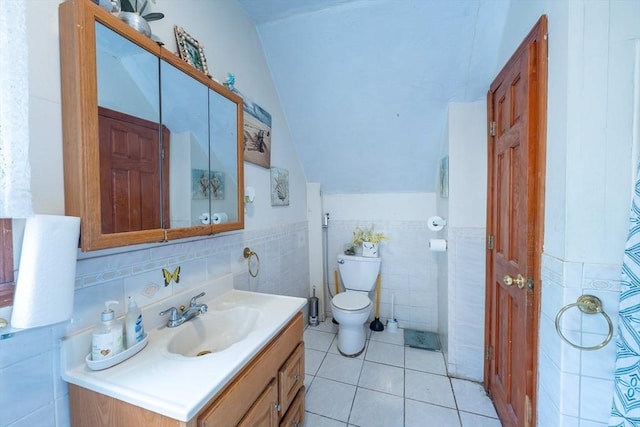 12 Charles St, Brockton, MA 02301 - full bathroom featuring vaulted ceiling, tile walls, vanity, toilet, and tile patterned floors