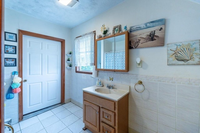 12 Charles St, Brockton, MA 02301 - bathroom featuring tile walls, vanity, tile patterned floors, and wainscoting