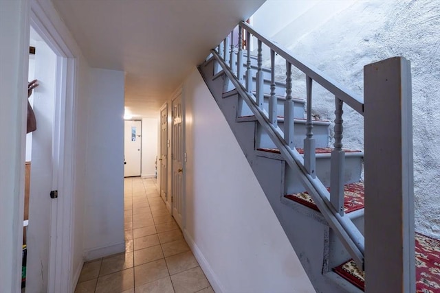 12 Charles St, Brockton, MA 02301 - corridor featuring light tile patterned floors, baseboards, and stairs