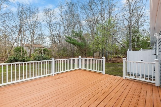 wooden deck featuring a yard