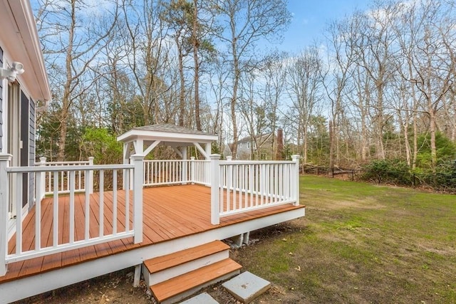 wooden deck with a lawn and a gazebo