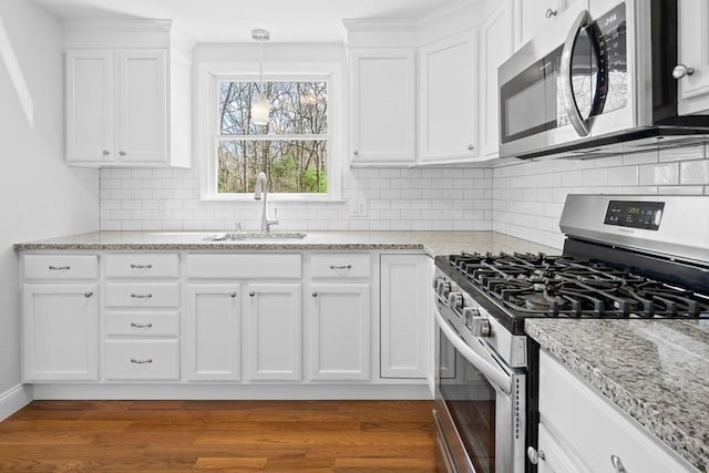kitchen featuring a sink, white cabinetry, and stainless steel appliances