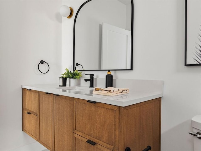 bathroom featuring vanity and toilet
