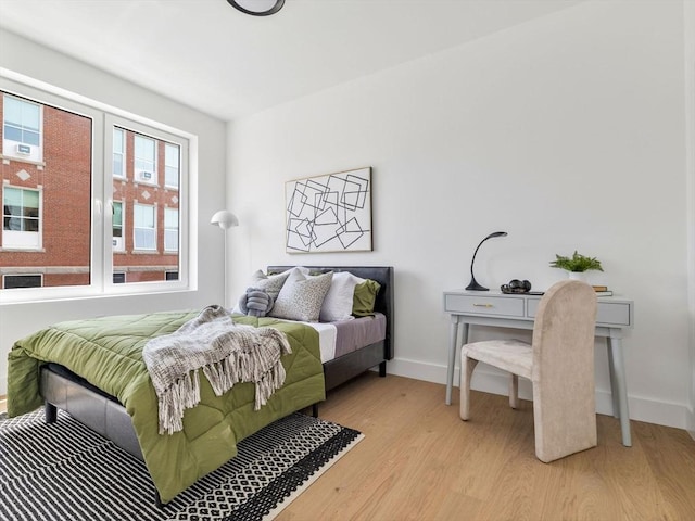 bedroom featuring baseboards and light wood-type flooring