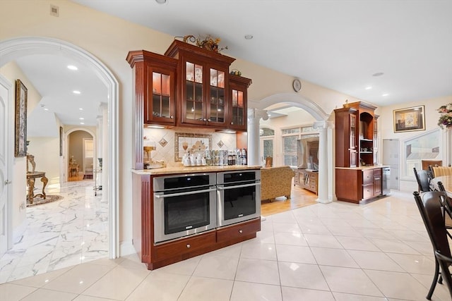 30 Bridle Path, Shrewsbury, MA 01545 - bar with bar, arched walkways, recessed lighting, decorative columns, and tasteful backsplash
