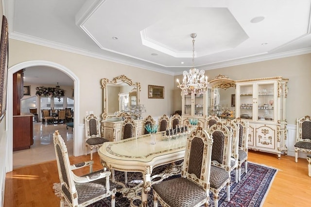 30 Bridle Path, Shrewsbury, MA 01545 - dining area featuring arched walkways, a notable chandelier, light wood-type flooring, and a raised ceiling