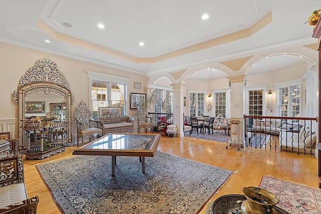 30 Bridle Path, Shrewsbury, MA 01545 - living area with ornate columns, arched walkways, a tray ceiling, and wood finished floors