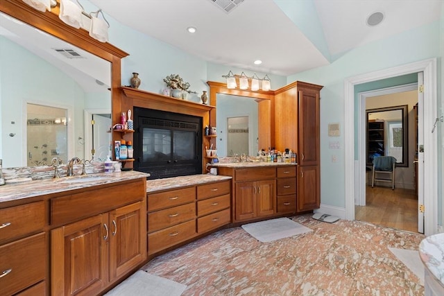 30 Bridle Path, Shrewsbury, MA 01545 - bathroom featuring visible vents, a shower stall, a sink, and a glass covered fireplace