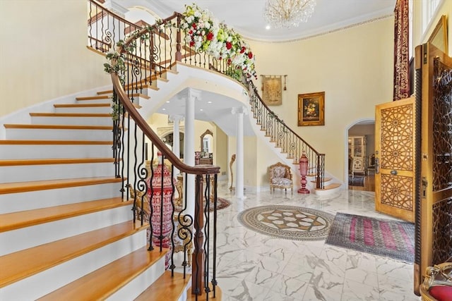 30 Bridle Path, Shrewsbury, MA 01545 - stairs featuring an inviting chandelier, arched walkways, marble finish floor, a towering ceiling, and ornamental molding