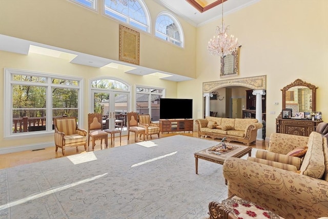 30 Bridle Path, Shrewsbury, MA 01545 - interior space with a towering ceiling, wood finished floors, a chandelier, ornamental molding, and ornate columns
