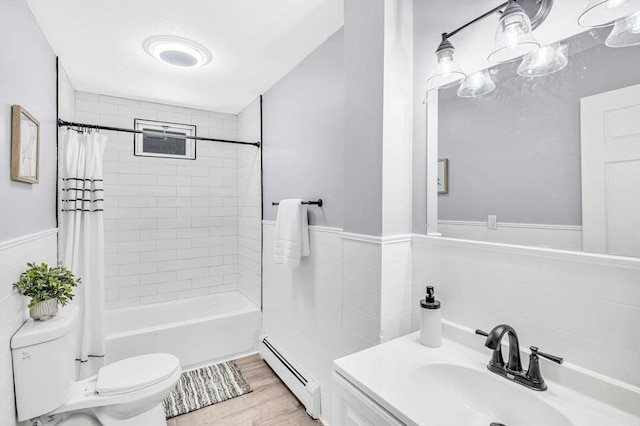 full bathroom with a baseboard radiator, shower / bath combo, hardwood / wood-style floors, toilet, and vanity