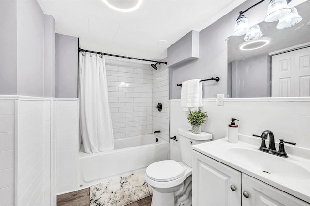 full bathroom with hardwood / wood-style floors, vanity, tile walls, and toilet