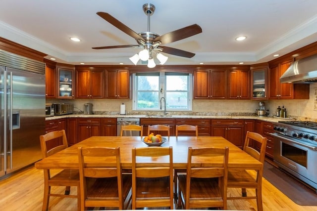 kitchen with high quality appliances, a sink, a ceiling fan, decorative backsplash, and recessed lighting