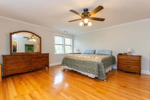 bedroom with light wood-type flooring, crown molding, baseboards, and ceiling fan