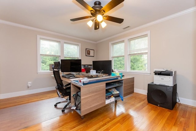 office space with crown molding, light wood-style flooring, baseboards, and a ceiling fan