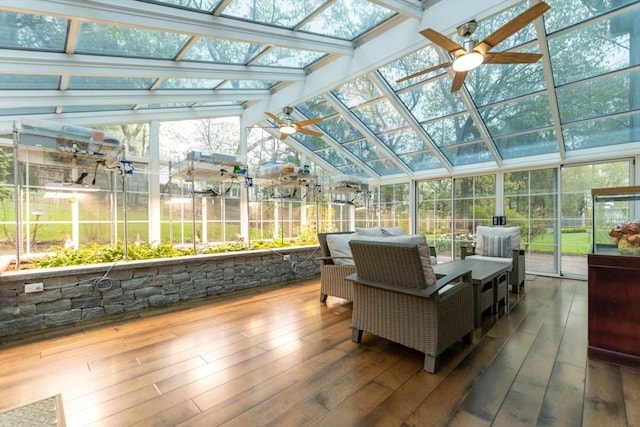 sunroom with a ceiling fan and vaulted ceiling