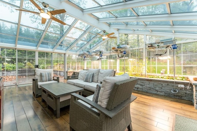 sunroom featuring ceiling fan, an outdoor hangout area, and lofted ceiling