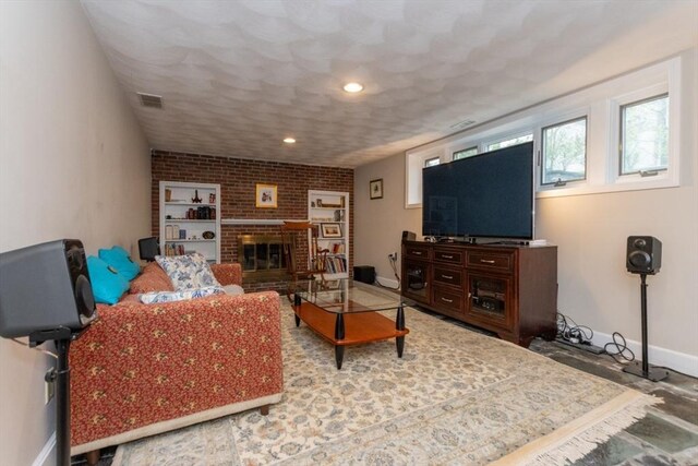 living area with baseboards, a brick fireplace, and recessed lighting